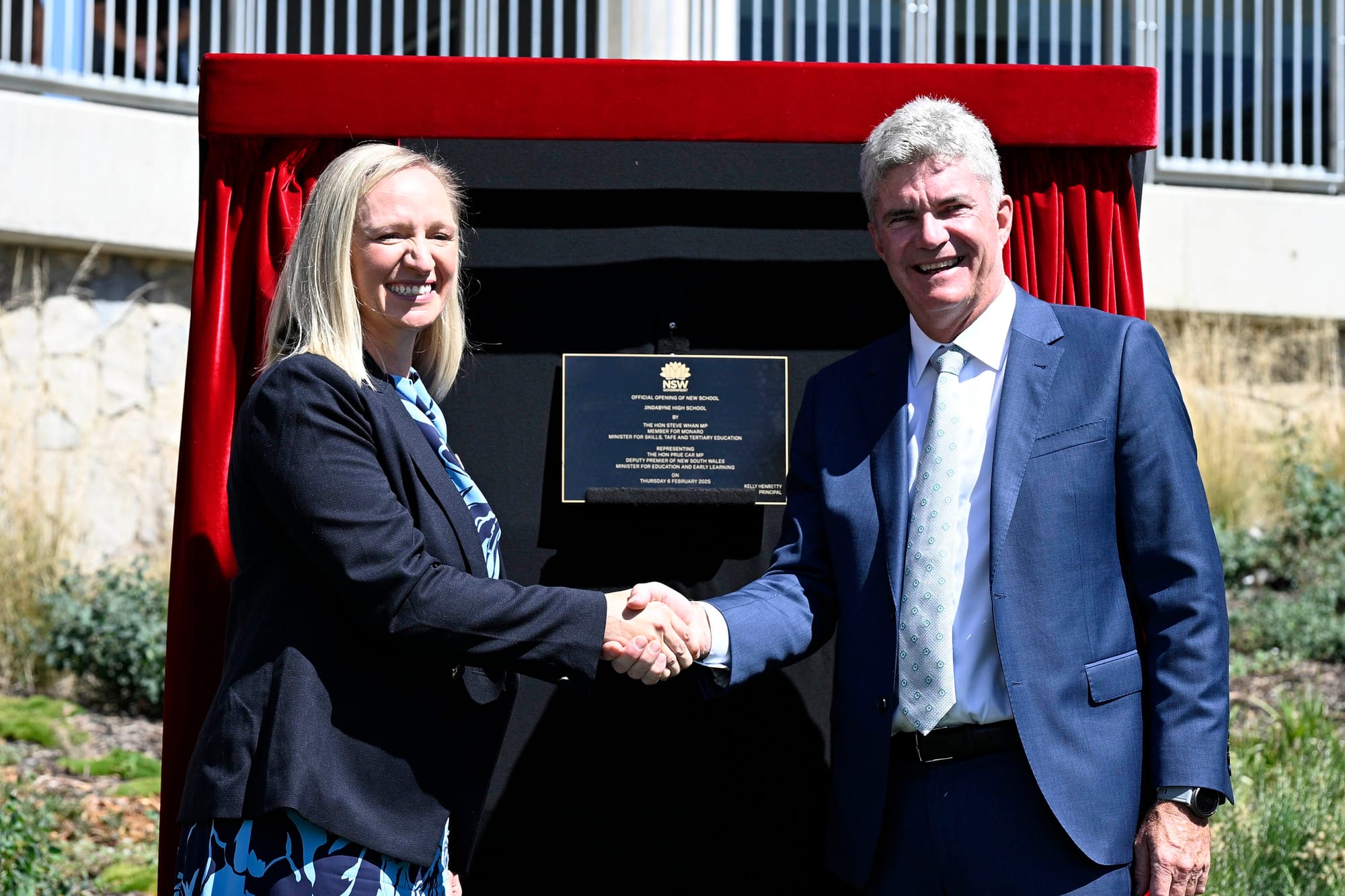 High School principal Kelly Henretty and Steve Whan unveil the official plaque.