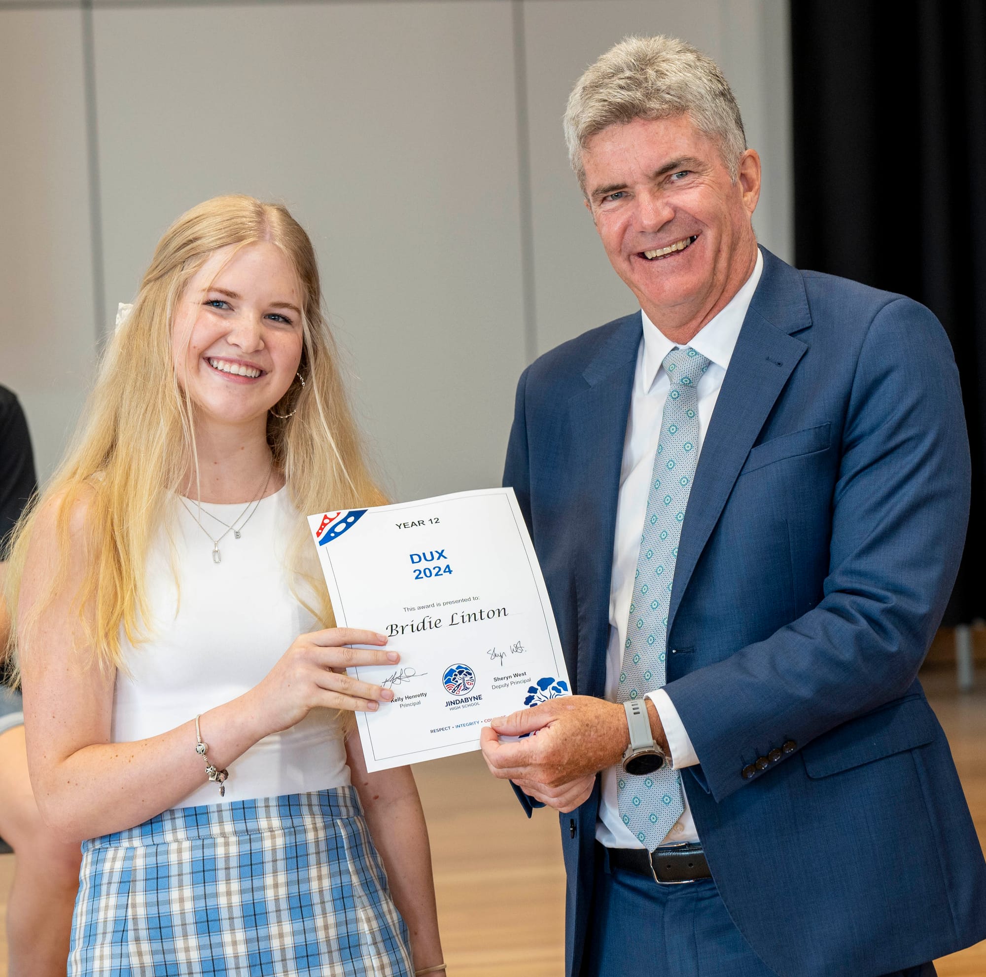 Bridie Linton receives her Dux of 2024 certificate from Steve Whan.