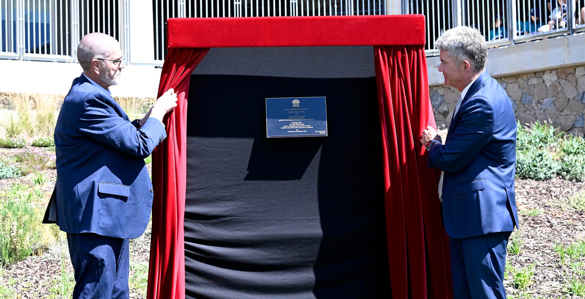 Steve McAlister and Steve Whan unveil the plaque.